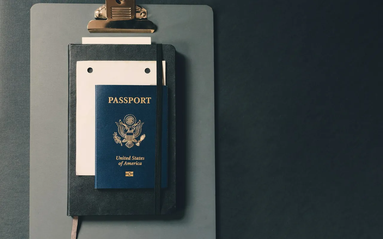 Passport and supporting paperwork on a clipboard
