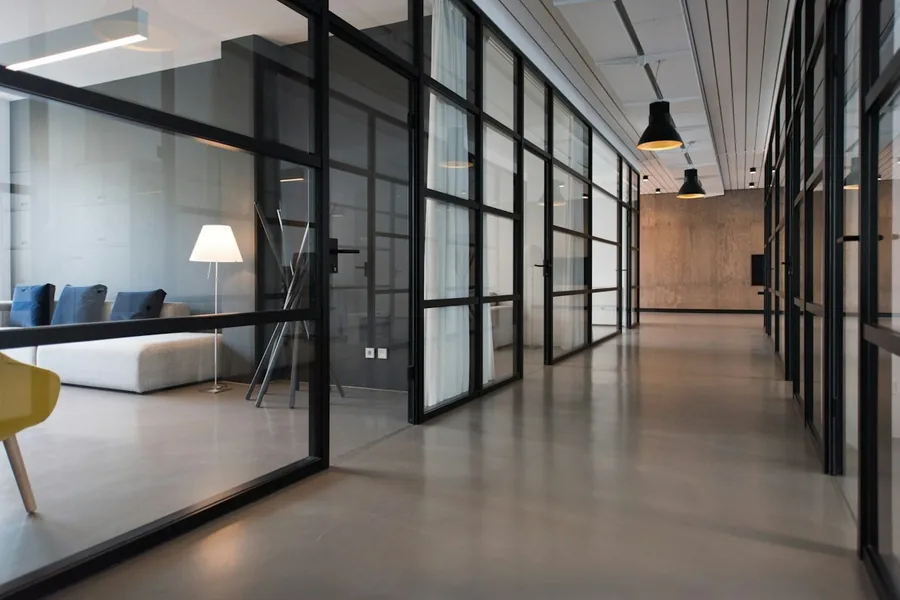 Stock photograph of a modern office hallway and shared workplace