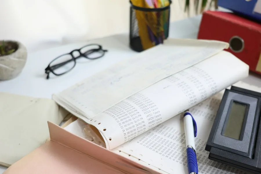 Financial records, calculator and glasses for a corporate governance review